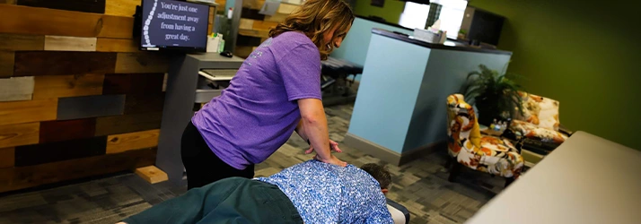 Chiropractor Bloomington IL Jess Bruin Adjusting Patients Back